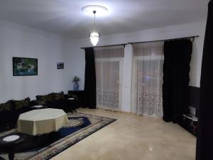 a living room with a couch and a table at Apartment in Villa - Tangier in Tangier