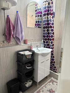 a bathroom with a sink and a mirror at Apartman JANA in Bileća