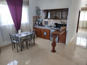 a kitchen with a table and chairs and a dining room at Apartment in Villa - Tangier in Tangier