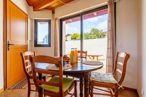 a dining room with a table and chairs and a window at Borda in Mouguerre