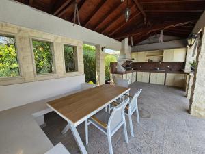 a kitchen and dining room with a wooden table and chairs at Luxury Villa Aurelia in Peyia
