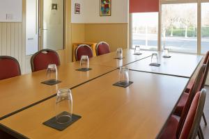 a conference room with a long table with glasses on it at The Kiln Hotel, Wakefield West Yorkshire, Part of the AG Collection in Wakefield
