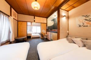 a hotel room with two beds and a couch at EDO GATEI Sakura Biyori Stay in Tokyo