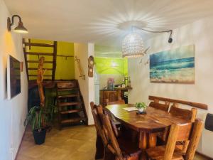 a dining room with a wooden table and chairs at Cabañas Playa del Sol in San Clemente del Tuyú