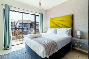 a bedroom with a large bed and a large window at Nom’s Amsterdam in Northriding +26 photos