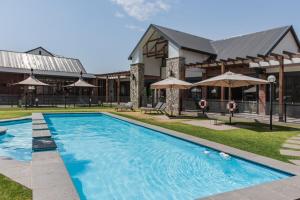 a large swimming pool in front of a building at Nom’s Amsterdam in Northriding