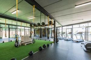 a gym with exercise bikes and a green floor at Nom’s Amsterdam in Northriding