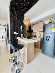 a kitchen with a counter and a blue refrigerator at Villas del mar in Cartagena de Indias