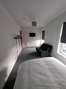 a living room with a bed and a couch at Alice house in Sunderland