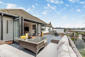 a patio with a couch and a table at Greenacres in Chittlehampton