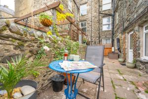 a blue table and a chair on a patio at Seren Fach in Barmouth