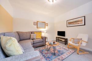 a living room with a couch and a table at Seren Fach in Barmouth