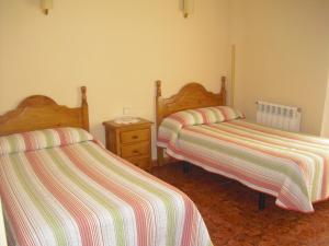 Postel nebo postele na pokoji v ubytování Hostal Sunami