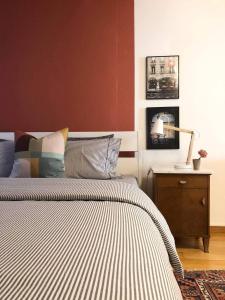 a bedroom with a bed and a table with a lamp at Steps To Bern's Best Historic Sites! in Bern