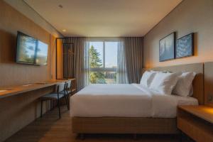 Ένα ή περισσότερα κρεβάτια σε δωμάτιο στο Golden Tulip Canela +19 φωτογραφίες
