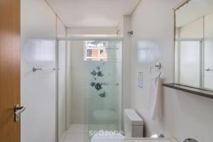 a bathroom with a glass shower with a toilet at Apto Vista Mar Lateral a 120m da Praia EEI0303 in Itajubá +33 photos