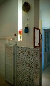 a kitchen with a refrigerator and a tile wall at Dar Essadeg in Tataouine +27 photos