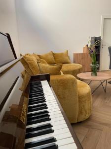 a living room with a piano and a couch at The White House Split in Split