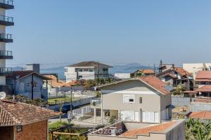 a view of a city with houses and buildings at Apto c/ Churrasqueira a 240m da Praia LUP0302 in Itajubá