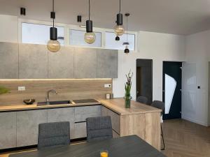 a kitchen with a sink and a table with chairs at The White House Split in Split +47 photos