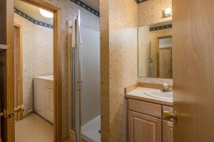 a bathroom with a sink and a tub and a shower at Beaverhead Condo | 105 Beaverhead #301 in Big Sky +27 photos