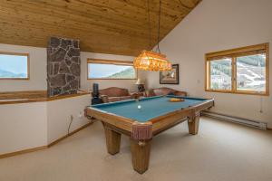 a room with a pool table in a house at Beaverhead Condo | 105 Beaverhead #301 in Big Sky