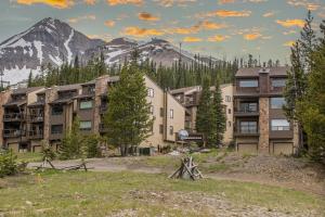 a group of buildings in front of a mountain at Beaverhead Condo | 105 Beaverhead #301 in Big Sky