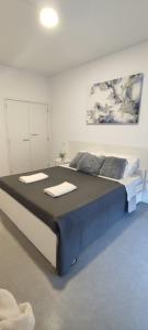 a bedroom with a large bed with towels on it at Porta 80 House in Braga