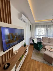 a living room with a large flat screen tv at Apartman LU Zlatibor in Zlatibor