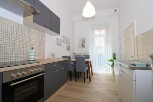 a kitchen with a table and a dining room at Altbauwohnung in Graz
