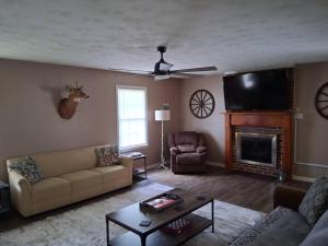 a living room with a couch and a fireplace at Old Wagon Lodge Spacious Retreat WiFi & Hot Tub Theater Room in Luray