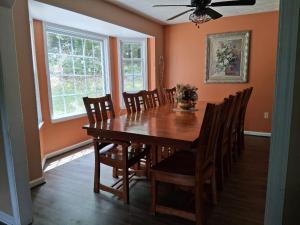 a dining room with a wooden table and chairs at Old Wagon Lodge Spacious Retreat WiFi & Hot Tub Theater Room in Luray