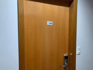 a wooden elevator door with a sign on it at Golden Dolphin Supreme in Caldas Novas +23 photos