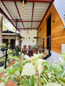 a patio with a house with a roof at sigiriya secret heaven cabana in Sigiriya