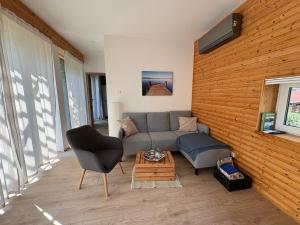 a living room with a couch and a chair at Tinyhaus Arendsee in Seenähe in Arendsee