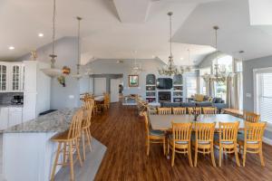 a kitchen and living room with a table and chairs at D3502 Sun King - Pool, Hot Tub, Pets OK, Oceanside in Duck