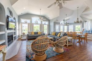 a living room with a couch and a table at D3502 Sun King - Pool, Hot Tub, Pets OK, Oceanside in Duck