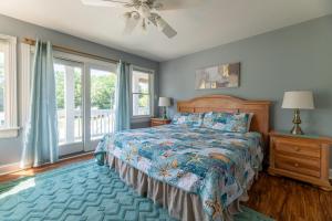a bedroom with a bed and a ceiling fan at D3502 Sun King - Pool, Hot Tub, Pets OK, Oceanside in Duck +67 photos