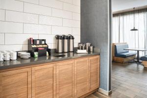 a kitchen with a counter and a table and chairs at Fairfield Inn & Suites by Marriott Tijuana in Tijuana