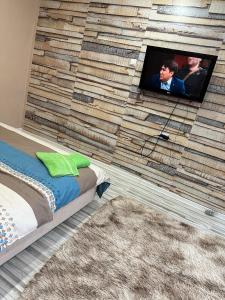a room with a wall with a tv on it at 1-комнатная квартира студия in Ekibastuz