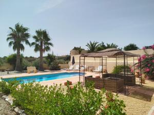 a swimming pool with a gazebo and a resort at La Casa Montana in Urcal