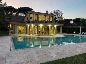 a large house with a pool in front of it at B&B Family Villa perfectly located in Rome