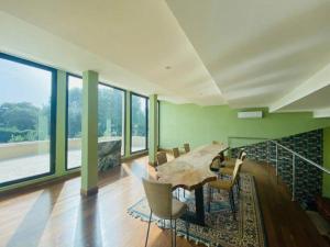 a dining room with a table and chairs and windows at B&B Family Villa perfectly located in Rome