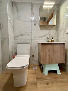 a bathroom with a white toilet and a sink at SummerLoft3 in Sivota +37 photos