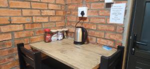 a wooden table with condiments on top of a brick wall at LyonsDen 2 in Worcester