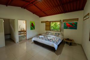 a bedroom with a large bed in a room at Tinamú Birding and Nature Lodge in Manizales