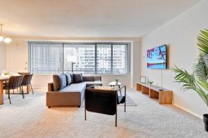a living room with a couch and a table at Elegant Apartment w Views at Crystal City in Arlington +21 photos