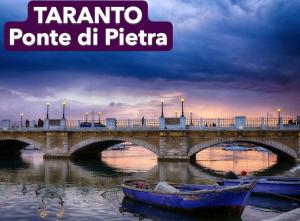 a bridge over a river with a boat on the water at Casa Vacanze del Salento in Sava