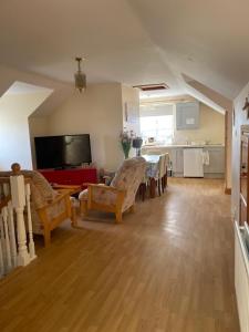 a living room with a dining table and a kitchen at Joe and Aggies in Kilclooney