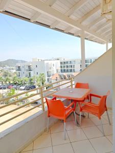 a balcony with a table and chairs on it at Hotel Azure in Dhërmi